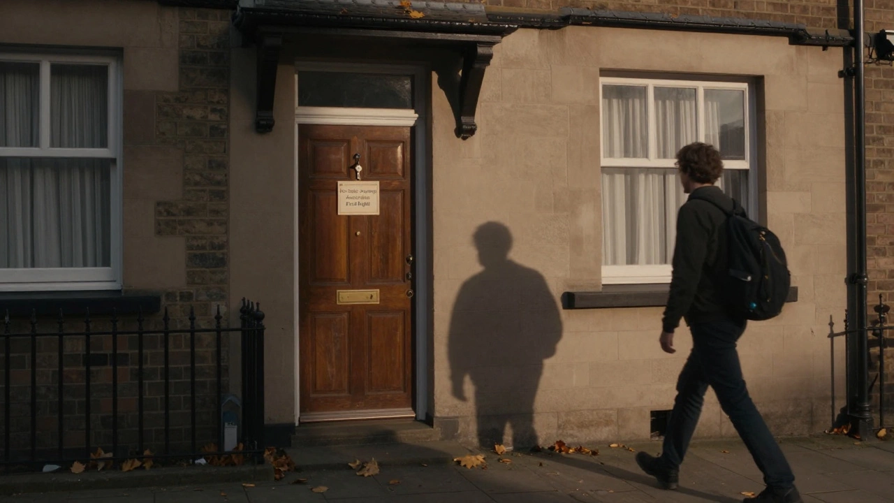 A key hangs by the door of a Manchester terrace house with a 'For Sale' sign noting housing association rights.